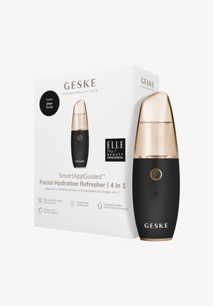 Zwarte gezichtsbevochtiger met een gouden deksel, voorzien van een knop en sensor. De doos bevat branding en productdetails in zwart-wit.