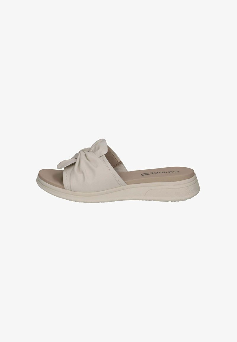 Sandales slides beige clair avec un détail de nœud sur la sangle, une semelle extérieure en caoutchouc et une semelle intérieure rembourrée pour le confort.