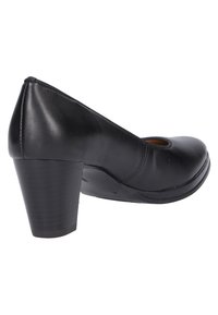 Black leather heeled shoe with a rounded toe and cutout detail. Features a sturdy block heel and smooth texture. Simple and clean design.