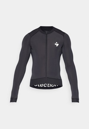 Langarm-Radsporttrikot, schwarz, mit einem Reißverschluss auf der Vorderseite, Rundhalsausschnitt, einem Logo auf der Brust und Netzdetails am Saum.