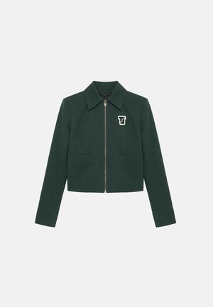 Veste zippée vert foncé avec col, deux poches avant et un logo blanc "TJ" sur la poitrine gauche.