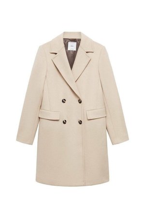 Manteau beige à double boutonnage avec un col cranté, deux poches avant et des boutons noirs. Fabriqué à partir d'un tissu lisse avec une silhouette structurée.