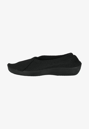 Black slip-on shoe with a textured knitted upper and a flexible rubber sole. The design features a rounded toe and minimal stitching accents.