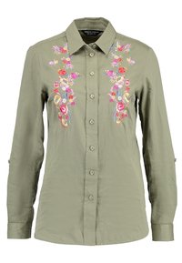 Camicia verde oliva a maniche lunghe con bottoni, ricamata con fiori colorati su entrambi i lati della patta frontale.