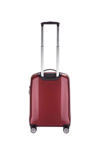 Valigia rigida rossa con finitura testurizzata, manico in alluminio retrattile e quattro ruote a 360 gradi per la mobilità.