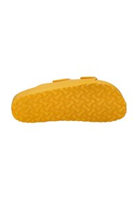 Yellow shoe with a textured rubber outsole, featuring a low profile and two adjustable straps for secure fit. Smooth, durable material.