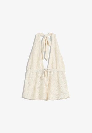 Haut en crochet ivoire à col halter avec un décolleté en V profond. Dispose d'une taille à cordon de serrage et de liens au cou, créant une silhouette fluide.