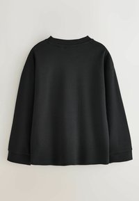 Schwarzes, übergroßes Sweatshirt mit langen Ärmeln, Rundhalsausschnitt und einem strukturierten Stoff. Schlichtes Design ohne sichtbare Logos oder Muster.