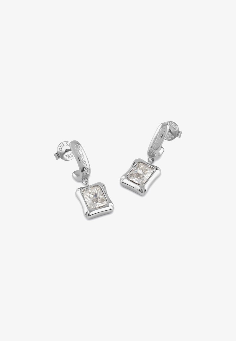 Orecchini a cerchio in argento con una goccia di pietra preziosa trasparente a forma quadrata. Il design presenta una finitura lucida e il nome del marchio incisa sull'hardware.