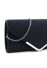 Pochette bleu marine avec une finition texturée, un rabat triangulaire, une bandoulière en chaîne argentée et un accent métallique incliné à l'avant.