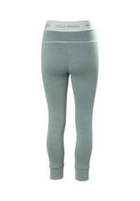 Lichtgroene leggings met een gestructureerd breipatroon. Heeft een witte elastische tailleband met "HELLYHANSEN" branding. Enkel-lang met aansluitende boorden.