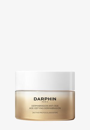 Crème Darphin Paris Age-Defying Dermabrasion dans un pot doré givré avec un couvercle blanc, étiquetée comme booster actif du protocole.
