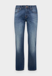 Jeans i denim i medium blå, med en rett benkutt. Middels høyde på midjen med subtil falming og kontrasterende sømmer. Fem-lommers design.
