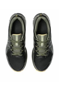 Black athletic shoes with mesh upper, green accents, and textured surface. Features laces, padded collar, and rubber sole.