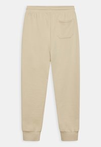 Calvin Klein Jeans MONOGRAM LOGO PANTS UNISEX - Träningsbyxor - muslin