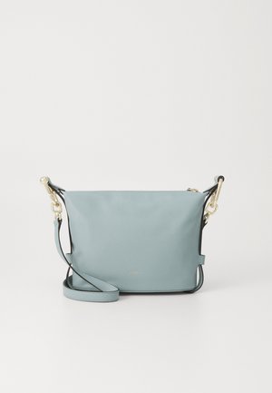 Light blue leather handbag with a smooth texture, featuring a long strap, gold hardware accents, and a subtle logo on the front.