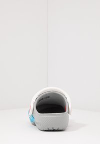 Gray back of a footwear with white heel strap, blue detailing, textured material, and a logo on the side. Designed for slip-on convenience.