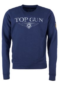 Marinblå sweatshirt med långa ärmar, ribbade muddar och rundad halsringning. Har en blek vit "TOP GUN"-logotyp och vingar grafik på framsidan.