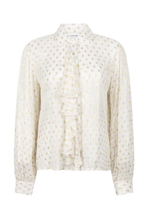 Witte blouse met lange mouwen, gouden stippen, een puntige kraag en een centrale ruchestrik aan de voorkant.