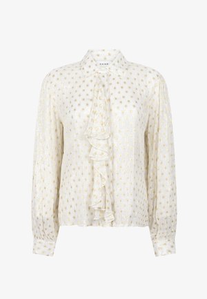 Witte blouse met lange mouwen, gouden stippen, een puntige kraag en een centrale ruchestrik aan de voorkant.