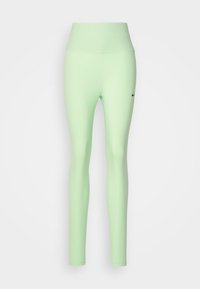 Jasnozielone legginsy z wysokim stanem i dopasowanym krojem. Posiadają małe czarne logo Nike z przodu. Gładka tekstura, bez widocznych wzorów.