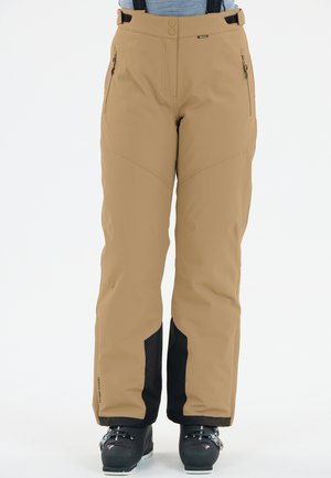 Beige skibroek met zwarte onderstukken, gemaakt van waterafstotend materiaal. Voorzien van verstelbare banden en ritssluitingen.