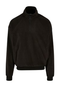 Svart fleece-pullover med høy krage, halv-glidelås foran og elastiske mansjetter og nederkant. Har to sidelommer. Myk tekstur.