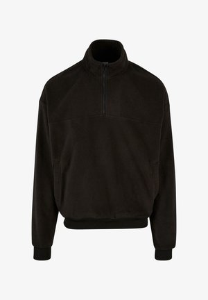 Fekete bolyhos pulóver magas gallérral, félig cipzárral az elején, elasztikus mandzsettákkal és aljjal. Két oldalzseb található rajta. Puha tapintású.