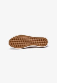 Rubber shoe sole featuring a honeycomb texture in brown and a white edge, with a smooth outer contour and no visible markings.