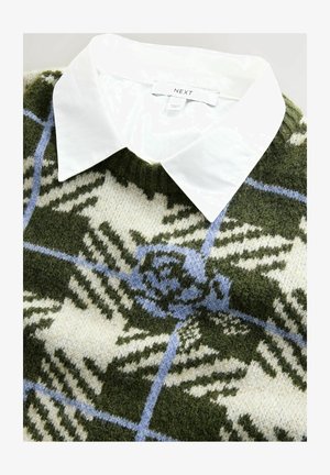 Pletený svetr s bílou límečkovou košile, zeleno-krémový kostkovaný vzor s modrými akcenty, měkká textura a žebrovaný výstřih.
