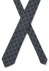 Cravatta a motivi in blu scuro con pois bianchi e motivi geometrici ripetuti. Tessuto morbido con un'estremità appuntita e silhouette slim.