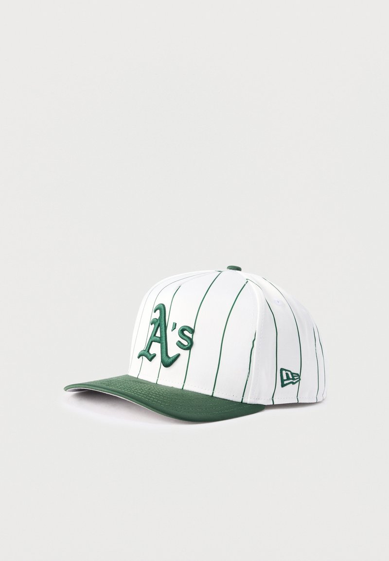 Λευκό καπέλο μπέιζμπολ με πράσινες λεπτές ρίγες, πράσινο γείσο και κεντητό πράσινο λογότυπο "A's" στο μπροστινό μέρος, εκτεθειμένο σε ανοιχτό φόντο.