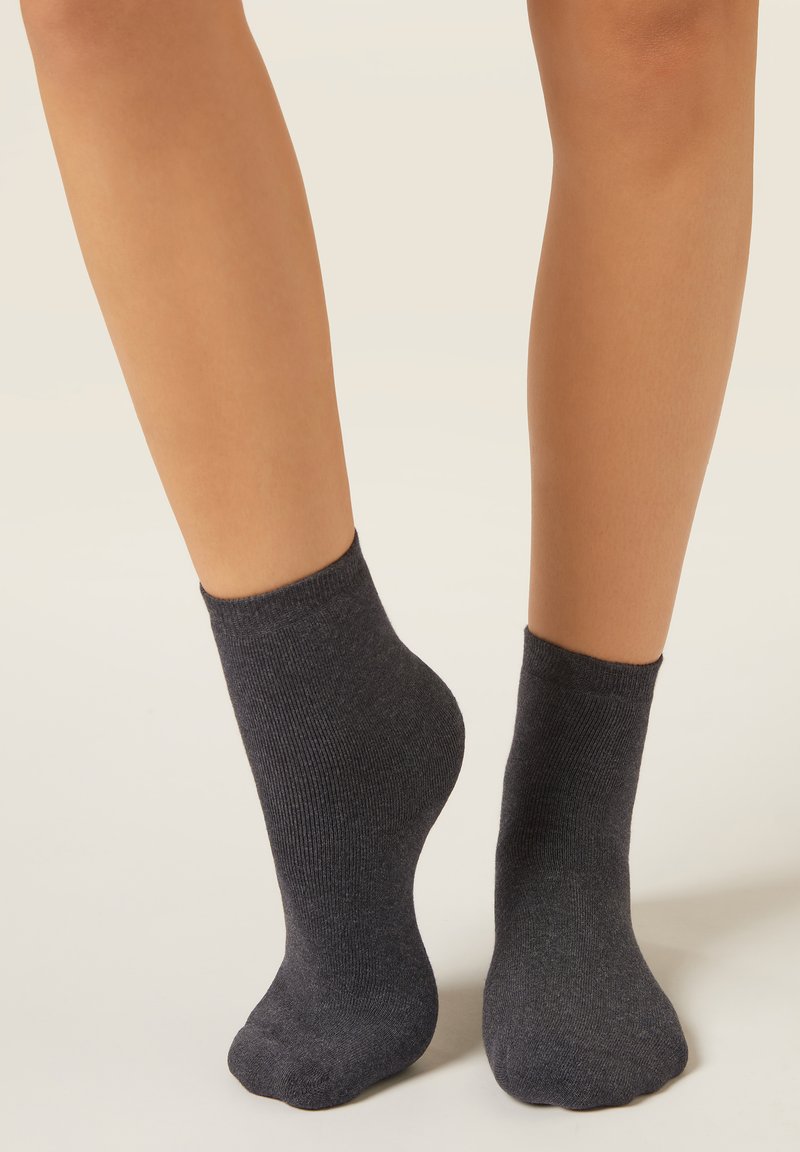 Dark gray ankle socks made of a soft, textured material; ribbed cuff with a rounded toe and seamless design.