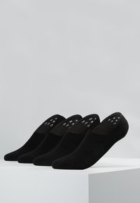 Schwarze unsichtbare Socken aus weichem Material mit einem No-Show-Design, ausgestattet mit strukturierten Silikon-Haftpunkten an der Ferse für zusätzlichen Halt.