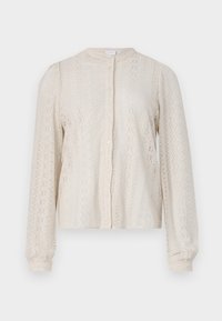 Cream lace blouse with long sleeves, round neckline, front button closure, and intricate floral patterns throughout. Textured fabric.