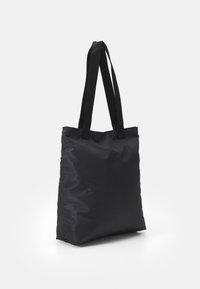 Svart tote-väska i mjukt, matt tyg. Rektangulär form med dubbel webbhandtag. Minimalistisk design utan mönster eller dekorationer.