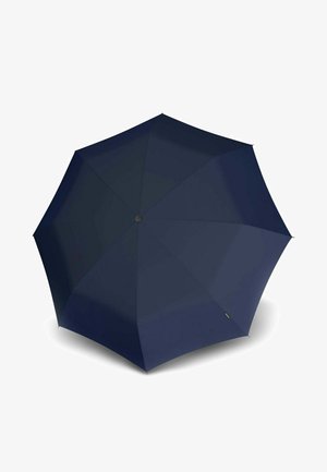 Navy blue umbrella opened, showing eight fabric panels with a central black button and a small tag near the edge.