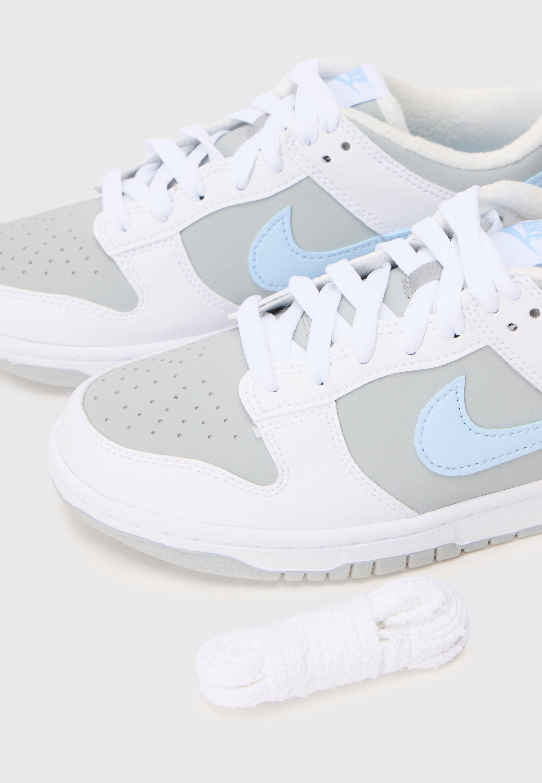 white and blue nike sneakers