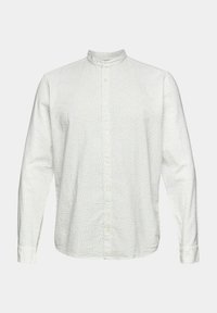 Chemise blanche à manches longues avec un petit motif à pois gris clair et un col montant sur fond neutre.