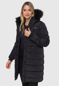 Black puffer coat with a faux fur hood, featuring quilted texture, multiple pockets, and a zipper closure with snap buttons.