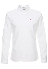 Witte lange mouwen blouse van katoen. Voorzien van een klassieke kraag, een linker borstzak en een klein logoaccent. Soepele textuur.
