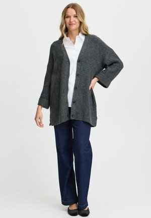 Charcoal gray cardigan with ribbed texture, oversized fit, open front, and five buttons, paired with dark denim pants and black flats.