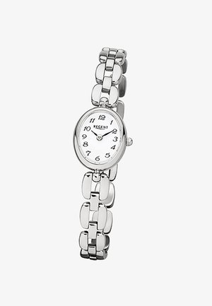 Montre bracelet en métal argenté avec un cadran oval blanc et des chiffres arabes noirs indiquant l'heure 10:10.