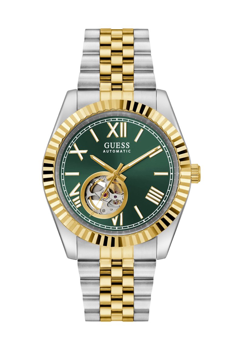 Ceas automatic din aur și argint cu un cadran verde. Caracteristicile includ numerale romane, display deschis al mecanismului și un bezel texturat.