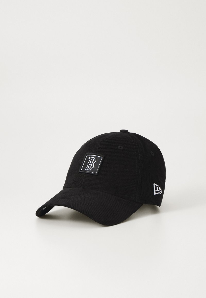 Black corduroy cap with rounded crown, curved visor, and embroidered logo patch. Features contrasting stitching and adjustable strap.