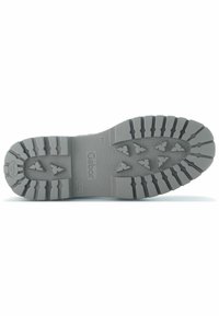 Gray rubber shoe sole with a rugged tread pattern, featuring defined traction lugs and a smooth central area, embossed brand name "Gabor."