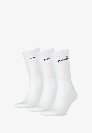 Weiße Baumwollsocken mit Rippstruktur, auf dem Bund mit schwarzem Logo versehen. Drei Paare präsentiert, glatte Oberfläche und standardmäßige Sockeform.