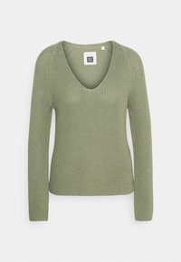 Trui met lange mouwen van geribbelde breiwerk in zacht olijfgroen met een V-halsontwerp, voorzien van een aansluitend silhouet en naadloze schouders.
