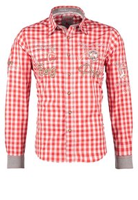 Chemise à manches longues à carreaux rouges et blancs avec texte brodé et écussons, fermeture boutonnée devant, col et poignets gris.
