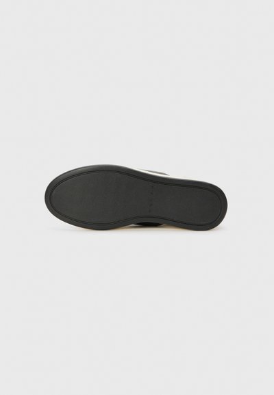 Black rubber shoe sole with a textured finish, featuring a curved shape and a slight heel, designed for traction and durability.